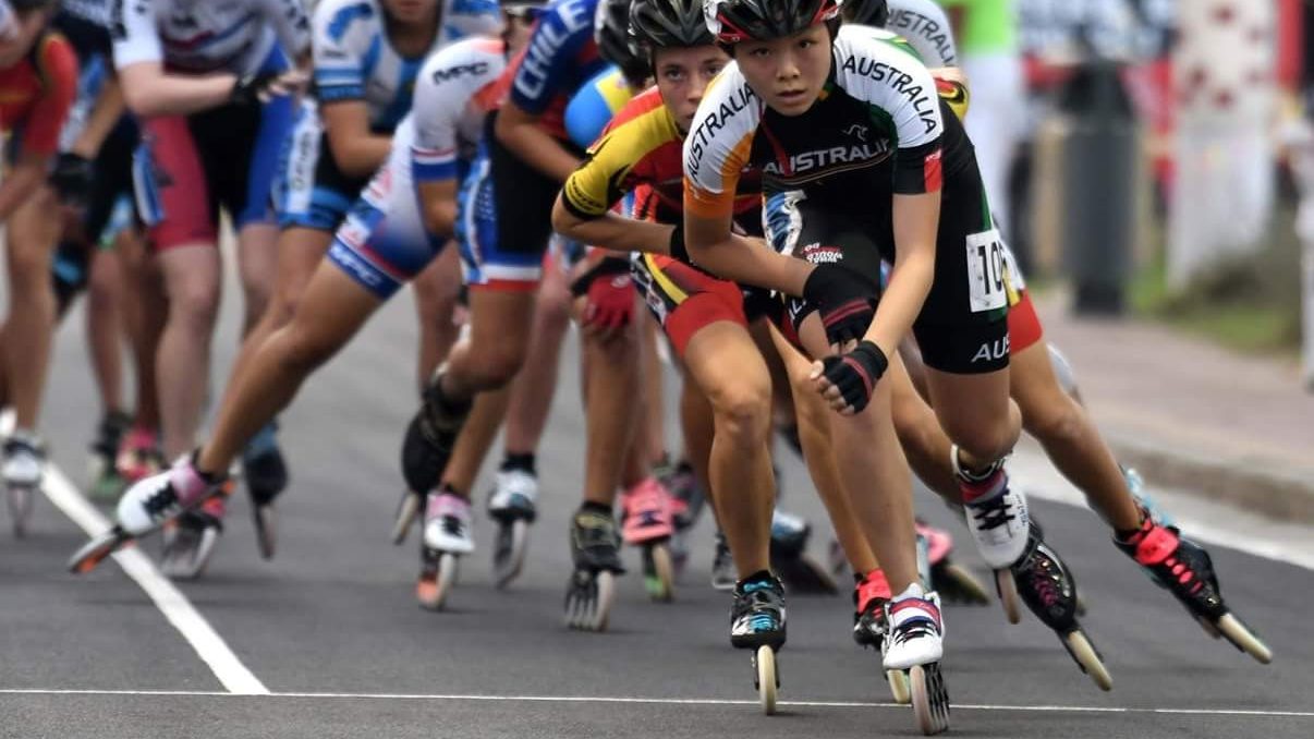Women speed skating in a road race